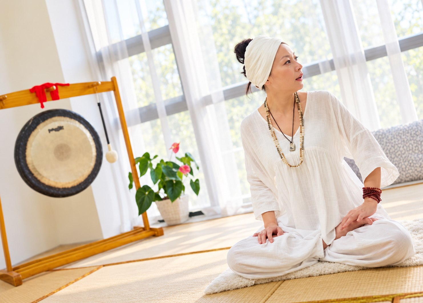 Wang Lin, HARI SHABAD KAUR, seated in white beside a gong